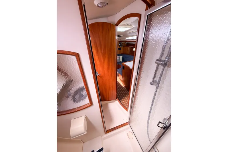 Slide: The Image of Interior of 2005 Hunter 36 yacht showing bathroom and cabin with wooden accents. - 52