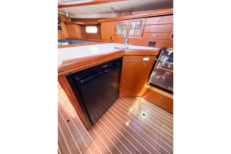 Slide: The Image of Interior of 2005 Hunter 36 sailboat kitchen with wood cabinetry and appliances. - 55