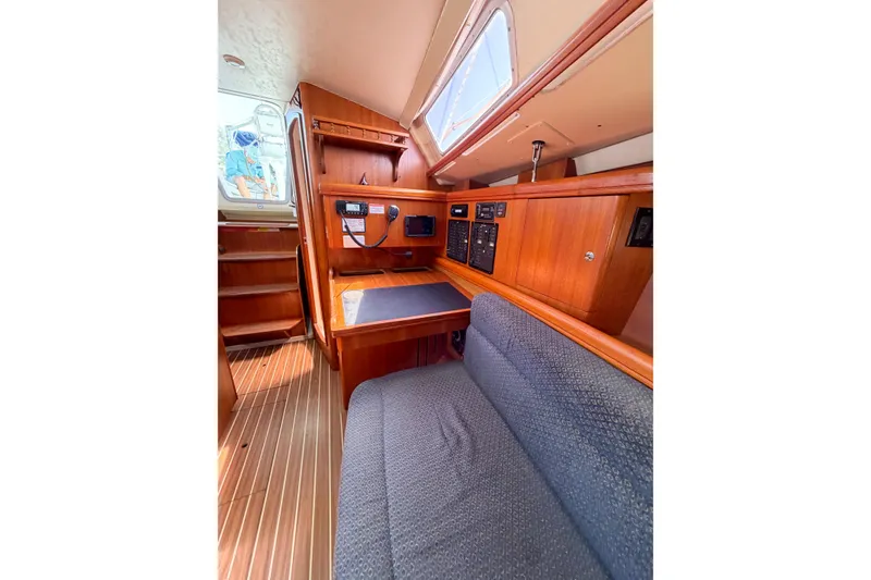 Slide: The Image of Interior of a 2005 Hunter 36 sailboat with wooden cabinetry and seating area. - 57