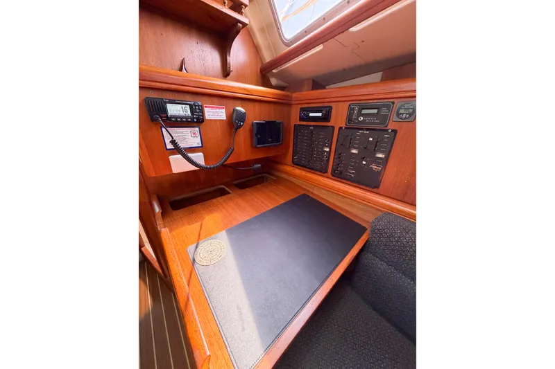 Slide: The Image of Navigation station of 2005 Hunter 36 sailboat with control panels and radio equipment. - 58