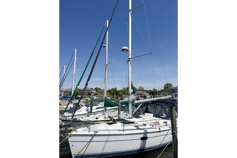 Slide: The Image of 2005 Hunter 36 sailboat docked at marina under clear blue sky. - 6