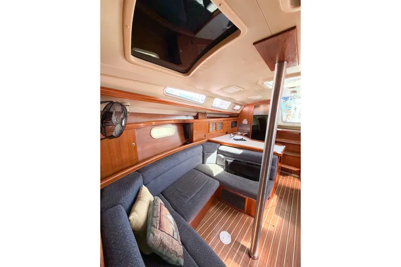Slide: The Image of Interior of 2005 Hunter 36 sailboat with cozy seating and wooden finishes. - 60