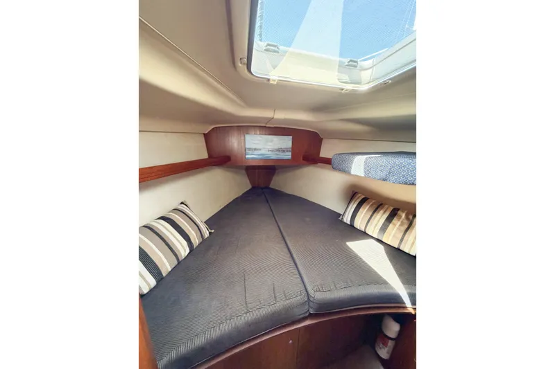 Slide: The Image of Cozy cabin interior of 2005 Hunter 36 sailboat with striped cushions and skylight. - 61