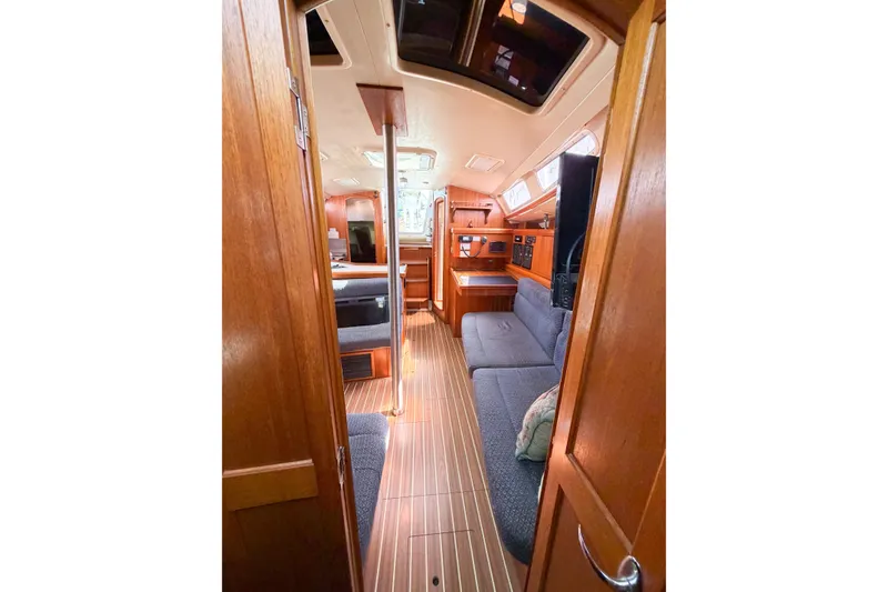 Slide: The Image of Interior of 2005 Hunter 36 sailboat with wood finish and cozy seating area. - 62