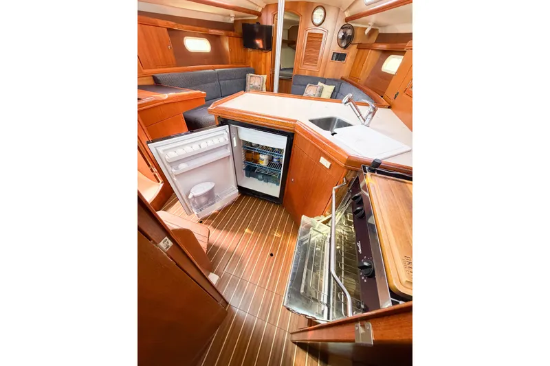 Slide: The Image of Interior of 2005 Hunter 36 sailboat featuring kitchen with open fridge and stove. - 64