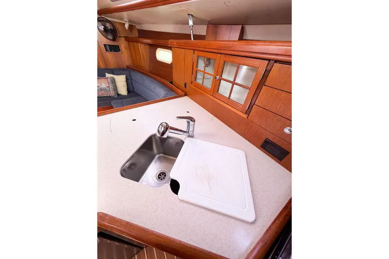 Slide: The Image of Interior of 2005 Hunter 36 sailboat galley with sink and wooden cabinetry. - 65