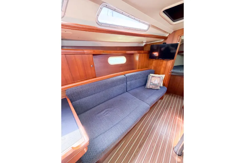 Slide: The Image of Interior of 2005 Hunter 36 sailboat with cozy seating and wooden finishes. - 66