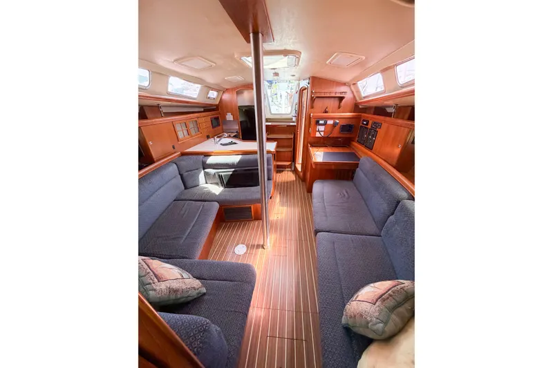 Slide: The Image of Interior of 2005 Hunter 36 sailboat with cozy seating and wooden finishes. - 67
