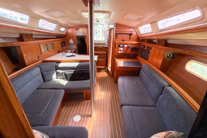 Slide: The Image of Interior of a 2005 Hunter 36 sailboat with cozy seating and wooden finishes. - 68