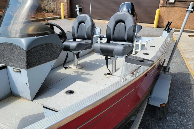 Slide: The Image of 2006 Lund 2000 Alaskan SS boat interior with dual seats and steering console. - 10