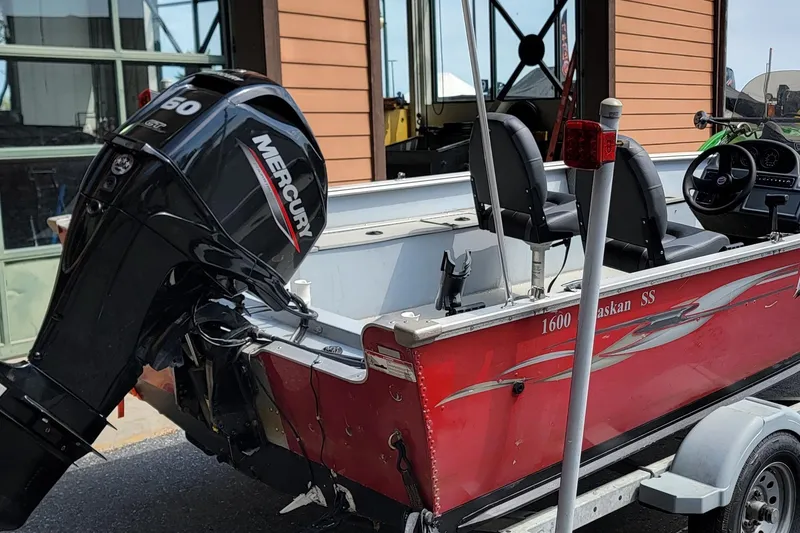 Slide: The Image of Red 2006 Lund 2000 Alaskan SS boat with Mercury outboard motor on trailer. - 2