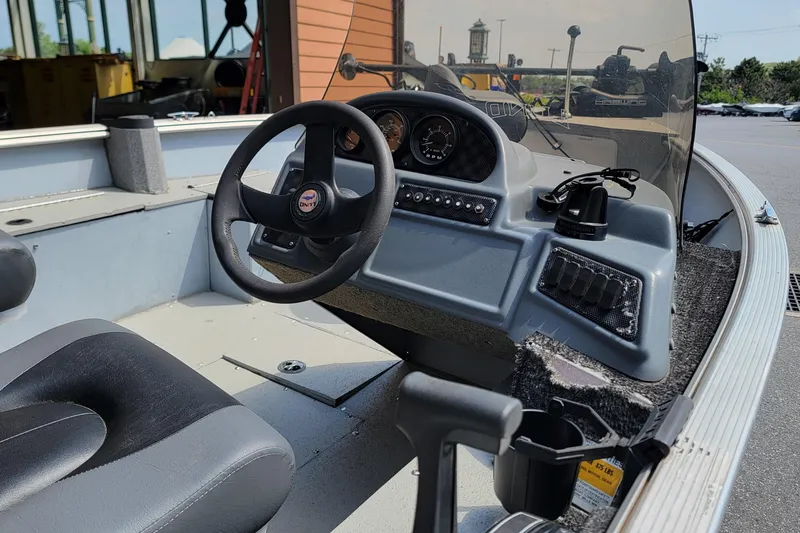 Slide: The Image of 2006 Lund 2000 Alaskan SS boat interior with steering wheel and dashboard controls. - 3