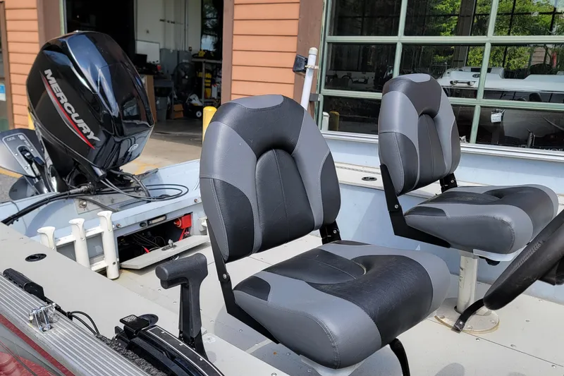 Slide: The Image of 2006 Lund 2000 Alaskan SS boat interior with Mercury outboard motor and two seats. - 5