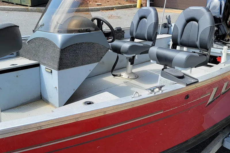 Slide: The Image of 2006 Lund 2000 Alaskan SS boat interior with dual seats and steering console. - 9