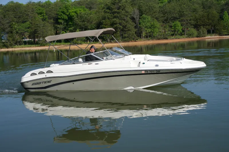 The Image of 2008 Ebbtide 2460 Z-Trak SS DC FC boat cruising on a calm lake. - 1