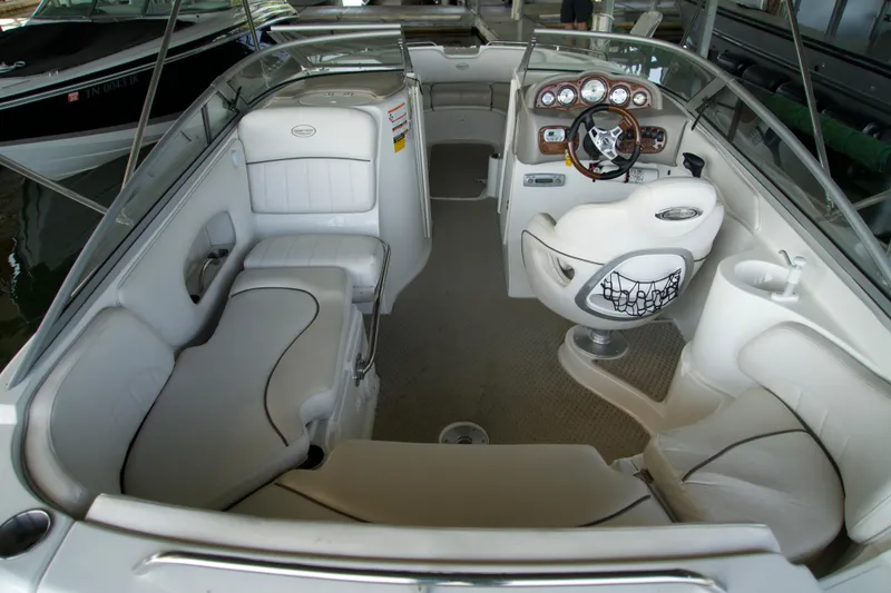 Slide: The Image of 2008 Ebbtide 2460 Z-Trak SS DC FC boat interior with white seating and steering console. - 11