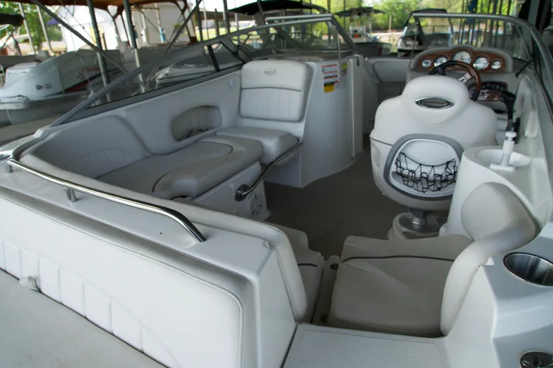 Slide: The Image of Interior of a 2008 Ebbtide 2460 Z-Trak SS DC FC boat with white seating and dashboard. - 12