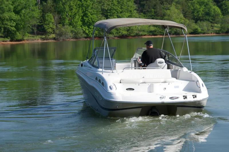 Slide: The Image of 2008 Ebbtide 2460 Z-Trak SS DC FC boat cruising on a serene lake. - 5