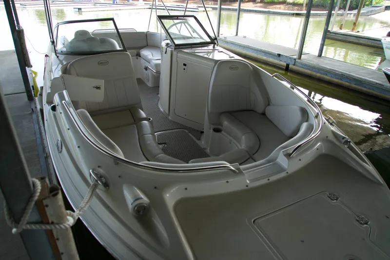 Slide: The Image of 2008 Ebbtide 2460 Z-Trak SS DC FC boat with spacious seating in a marina. - 6