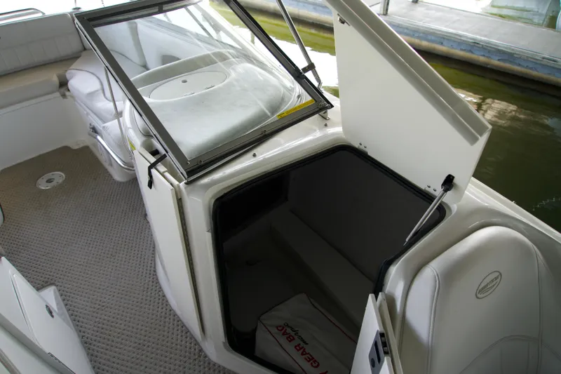 Slide: The Image of 2008 Ebbtide 2460 Z-Trak SS DC FC boat interior with open storage compartment. - 8