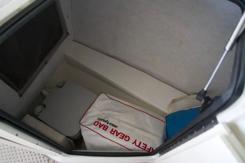 Slide: The Image of 2008 Ebbtide 2460 Z-Trak SS DC FC boat storage compartment with safety gear bag. - 9