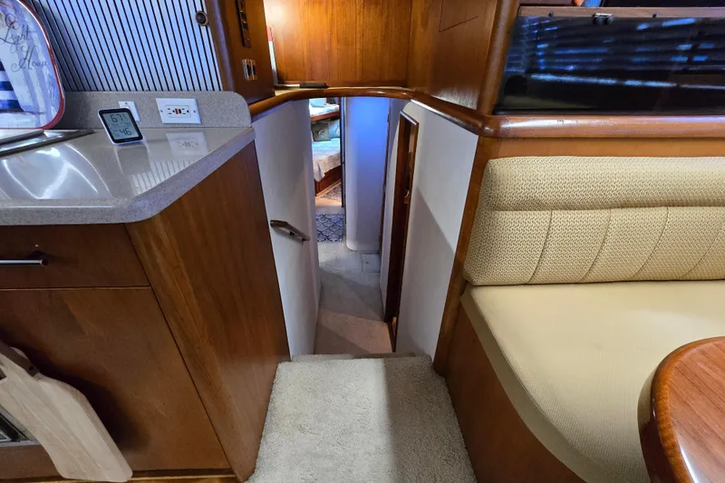 Slide: The Image of Interior of 1993 Ocean Yachts 53 Super Sport, featuring cozy seating and wooden cabinetry. - 15