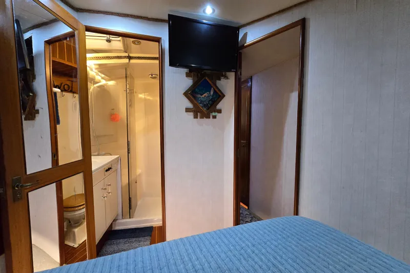 Slide: The Image of Interior of 1993 Ocean Yachts 53 Super Sport, featuring a cozy cabin and bathroom. - 17
