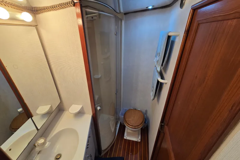 Slide: The Image of Bathroom interior of 1993 Ocean Yachts 53 Super Sport with shower and wooden accents. - 23