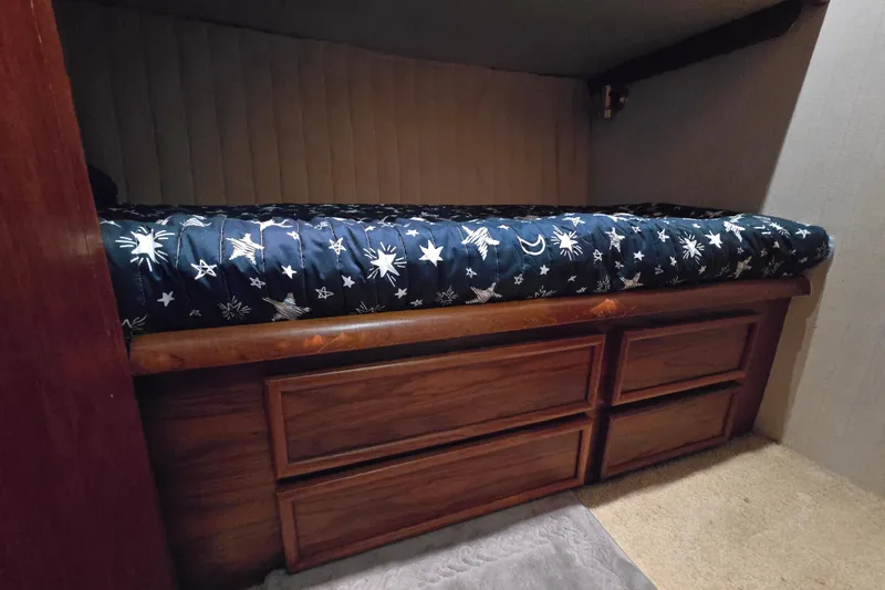 Slide: The Image of Cozy cabin bed with star-patterned bedding in 1993 Ocean Yachts 53 Super Sport. - 26
