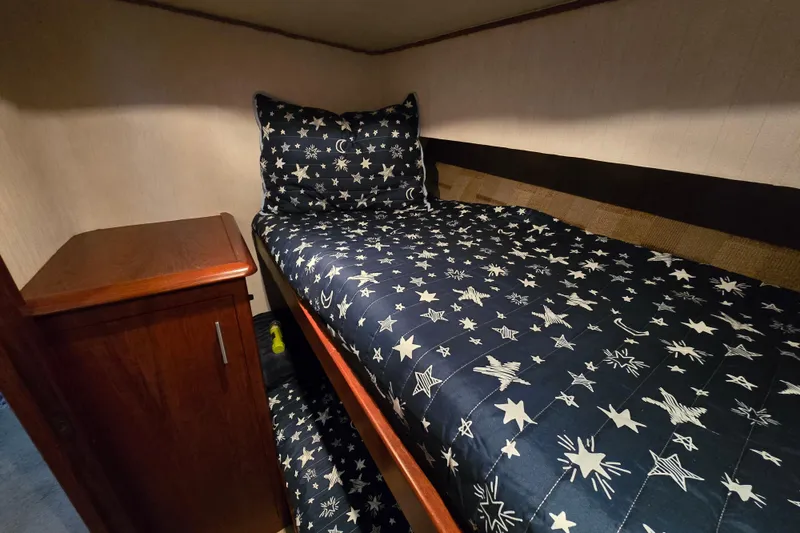 Slide: The Image of Cozy cabin bed with star-patterned bedding in 1993 Ocean Yachts 53 Super Sport. - 27