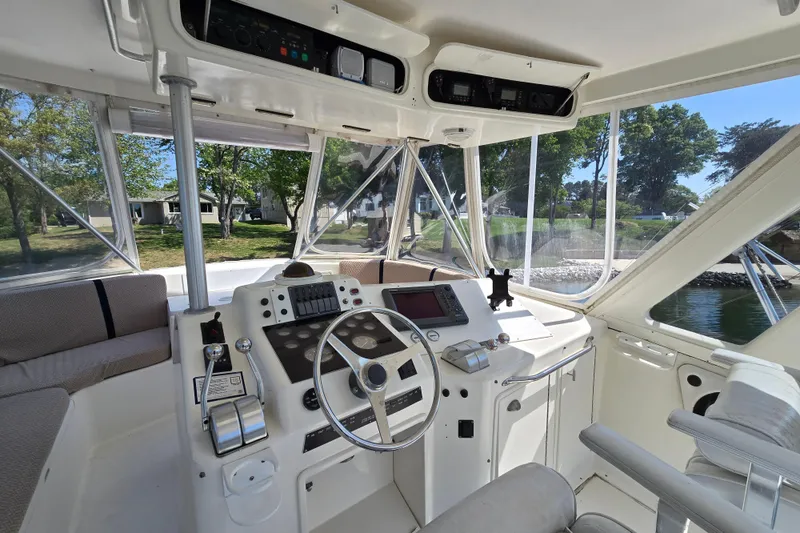 Slide: The Image of Interior helm of 1993 Ocean Yachts 53 Super Sport, featuring steering wheel and control panel. - 29