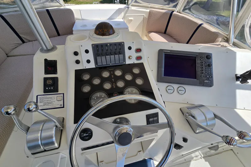 Slide: The Image of Cockpit of 1993 Ocean Yachts 53 Super Sport with steering wheel and navigation controls. - 32