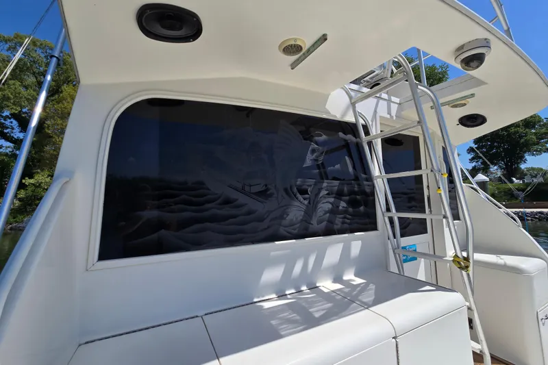 Slide: The Image of 1993 Ocean Yachts 53 Super Sport with ladder and tinted windows, docked outdoors. - 40