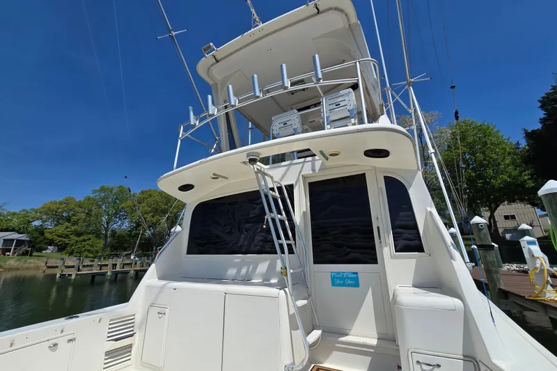 Slide: The Image of 1993 Ocean Yachts 53 Super Sport docked, showcasing rear view and upper deck. - 41