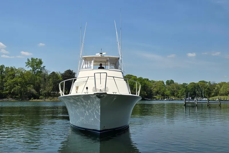 Slide: The Image of 1993 Ocean Yachts 53 Super Sport on calm water, surrounded by lush greenery. - 7