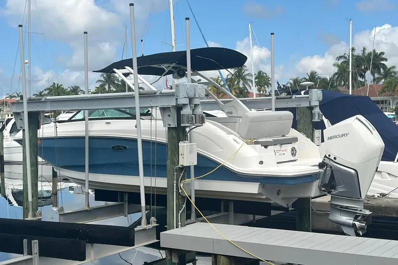 Slide: The Image of 2021 Sea Ray SDX 250 Outboard boat docked at marina with Mercury engine. - 10
