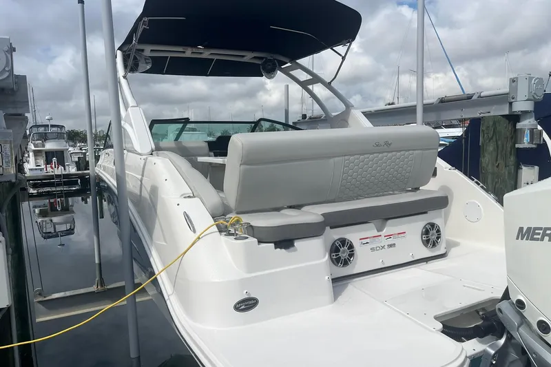 Slide: The Image of 2021 Sea Ray SDX 250 Outboard boat docked, featuring spacious seating and modern design. - 13