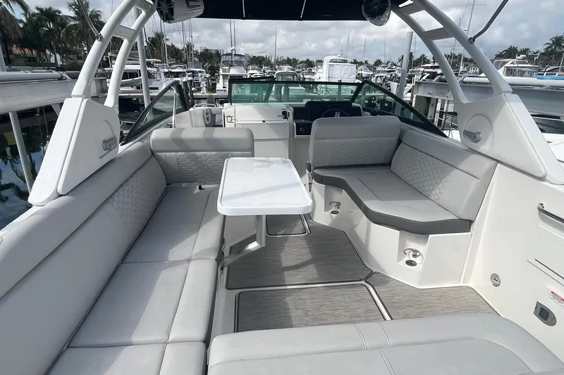 Slide: The Image of Luxurious 2021 Sea Ray SDX 250 Outboard boat interior with spacious seating and table. - 16