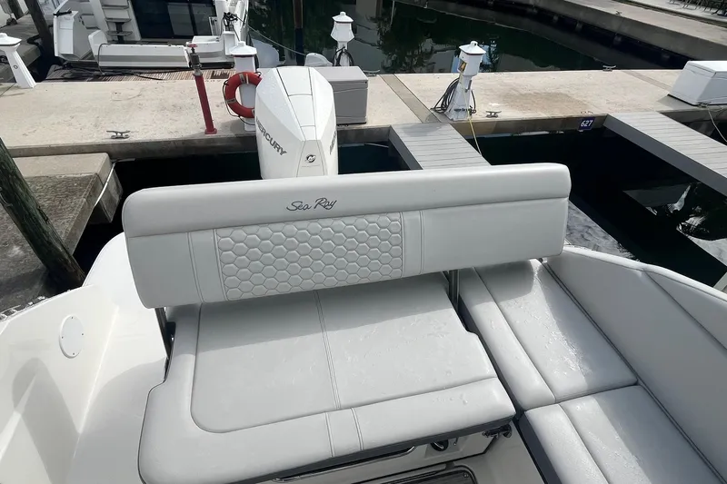 Slide: The Image of 2021 Sea Ray SDX 250 Outboard boat with white seating and Mercury engine at dock. - 18