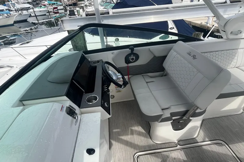 Slide: The Image of 2021 Sea Ray SDX 250 Outboard helm with modern controls and comfortable seating. - 20