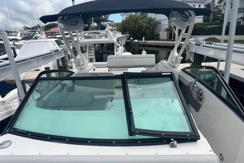 Slide: The Image of 2021 Sea Ray SDX 250 Outboard boat docked, featuring sleek design and spacious seating. - 24