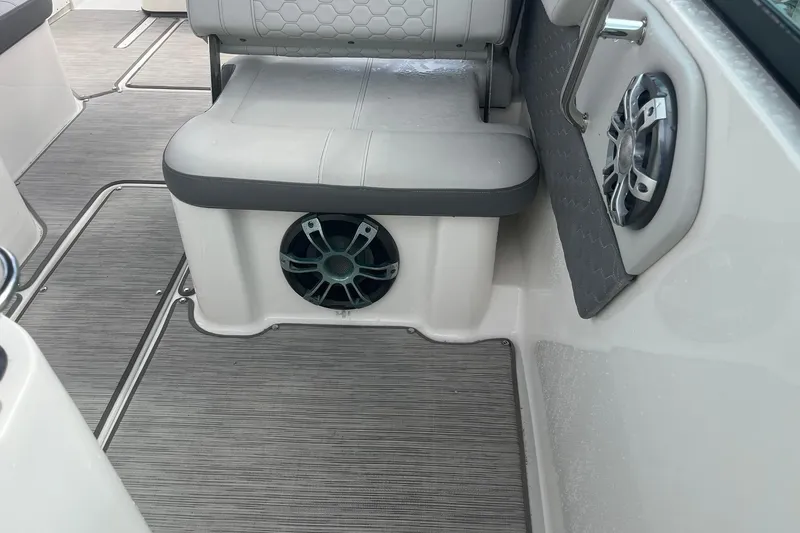 Slide: The Image of 2021 Sea Ray SDX 250 Outboard interior with seating and built-in speakers. - 31