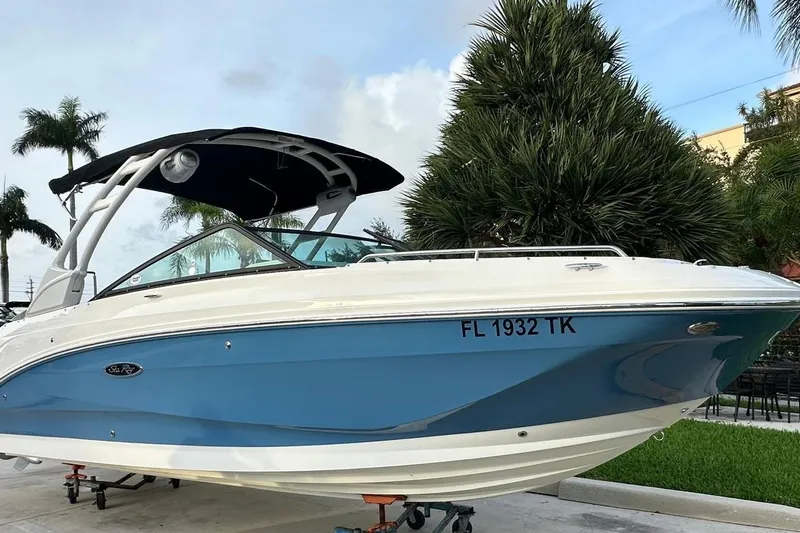 Slide: The Image of 2021 Sea Ray SDX 250 Outboard boat with blue hull, parked outdoors. - 5