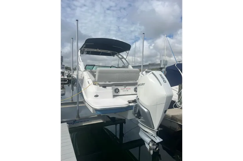 Slide: The Image of 2021 Sea Ray SDX 250 Outboard boat docked, featuring a Mercury engine. - 9