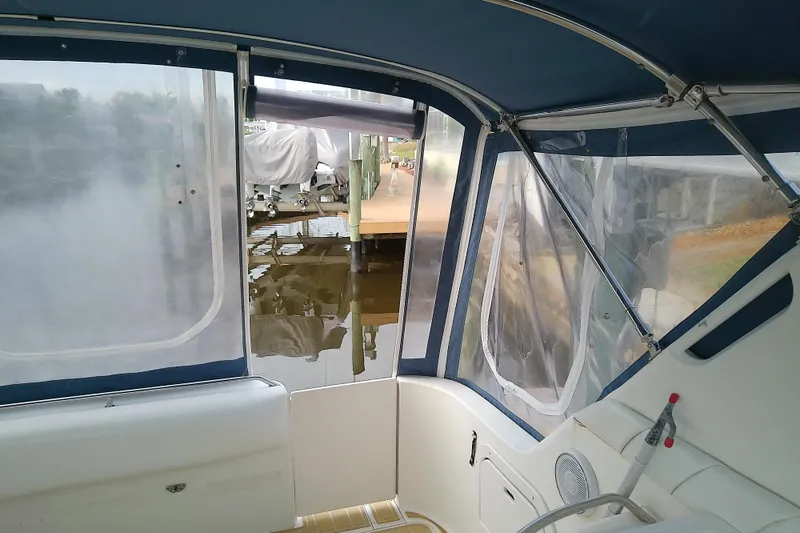Slide: The Image of Interior view of a 1998 Sea Ray Sundancer 330 boat with clear vinyl windows. - 11