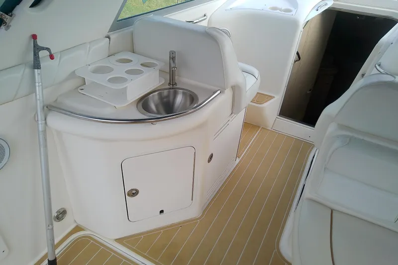 Slide: The Image of 1998 Sea Ray Sundancer 330 interior with sink and seating area. - 13