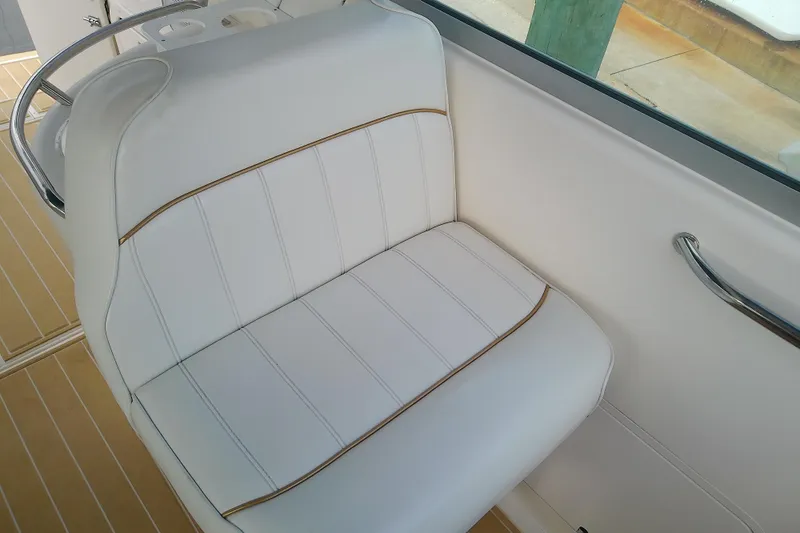 Slide: The Image of White leather seat on 1998 Sea Ray Sundancer 330 boat, featuring sleek design and stitching. - 15