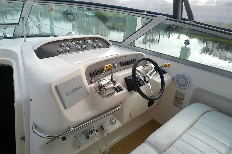 Slide: The Image of 1998 Sea Ray Sundancer 330 helm with Garmin navigation, steering wheel, and control panel. - 19