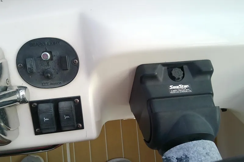 Slide: The Image of Control panel of a 1998 Sea Ray Sundancer 330 boat, featuring searchlight and switches. - 21