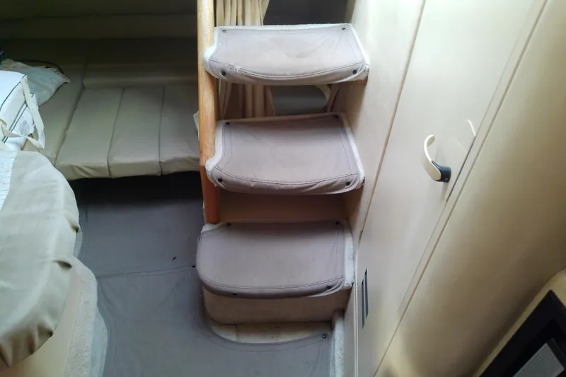 Slide: The Image of Interior stairs of a 1998 Sea Ray Sundancer 330 yacht, leading to a cozy cabin. - 27